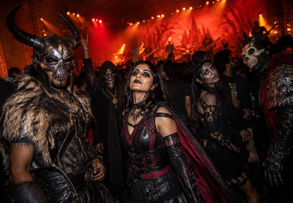 Fans in dark fantasy cosplay at a metal concert